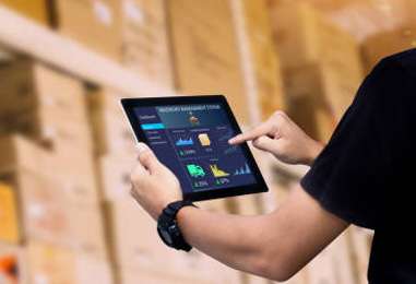 Warehouse associate reviewing inventory data on a tablet
