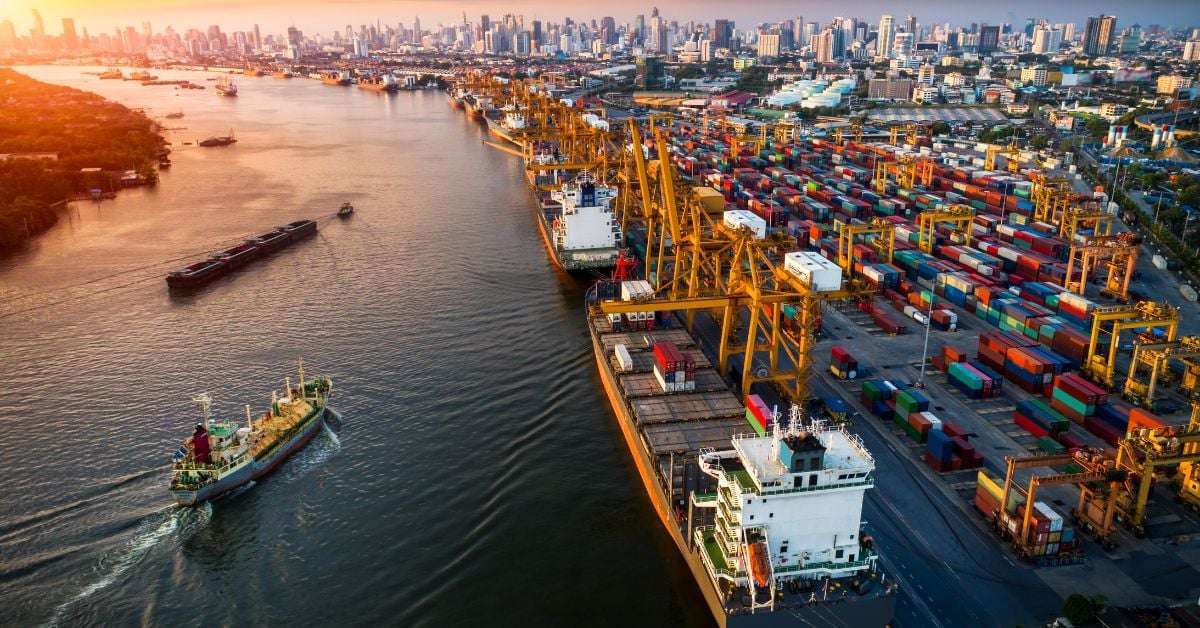 Aerial view of a shipping port with cargo containers at sunset