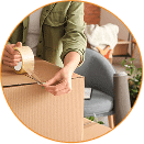 Boxzooka team member taping a shipping box for the Gilt Group cross border partnership