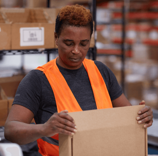 Warehouse associate assembling a shipping box