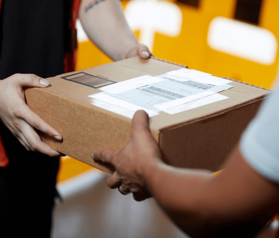 Close up of a package being handed off between two people