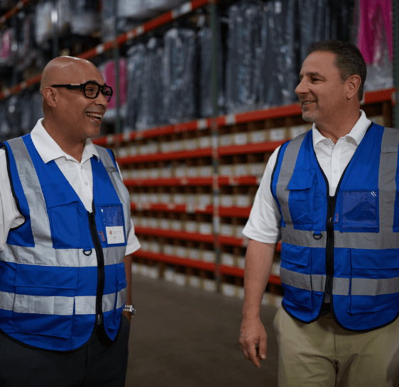 Two Boxzooka team members talking in branded vests