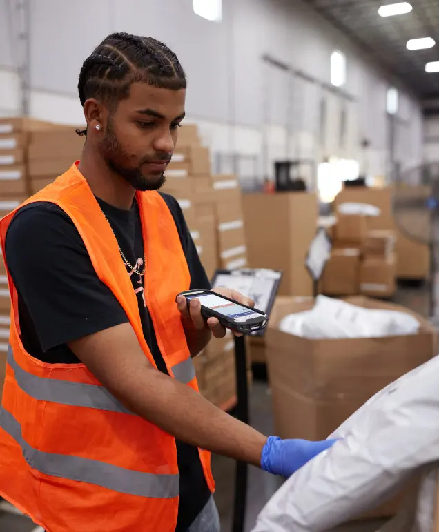 Warehouse associate scanning a package with a handheld device