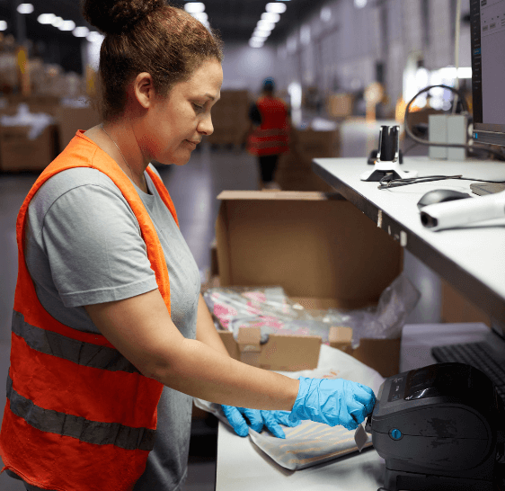 Warehouse associate preparing an order at a packing station