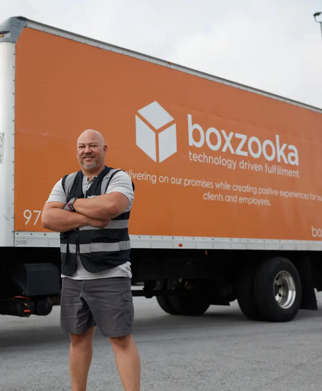 Boxzooka employee standing in front of a branded delivery truck