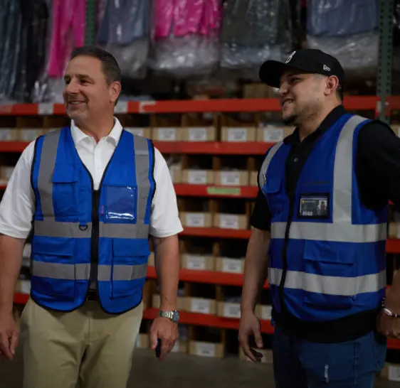 Two Boxzooka team members in branded vests in the warehouse
