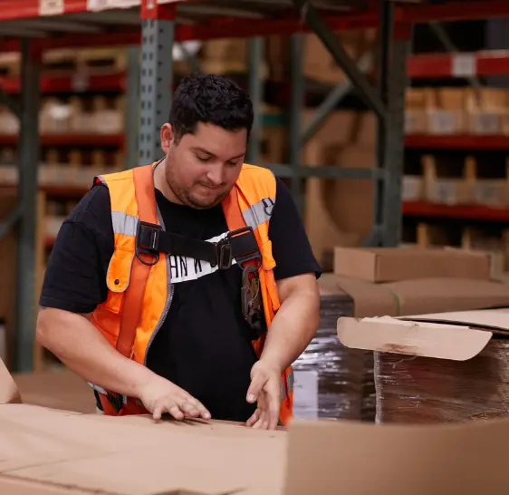 Warehouse associate packing a box