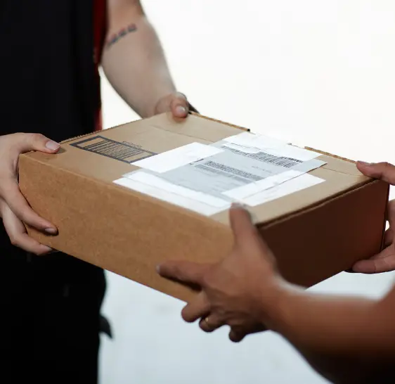 Close up of a package being handed off between two people