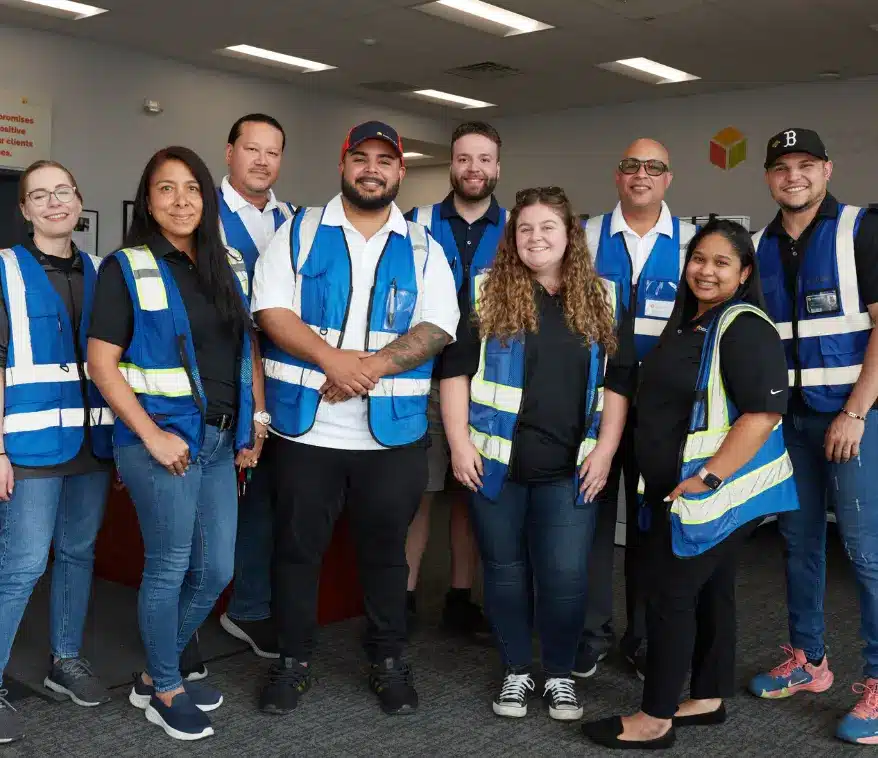 Boxzooka team members standing together in the office, reflecting company culture built on teamwork, inclusivity, and employee pride.