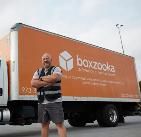 Boxzooka employee standing in front of a branded delivery truck