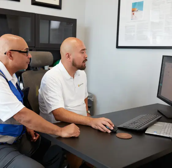 Two Boxzooka employees reviewing data at an office computer
