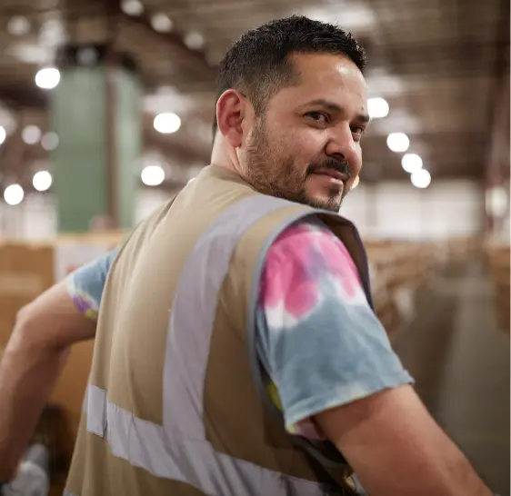 Portrait of a warehouse associate among storage racks