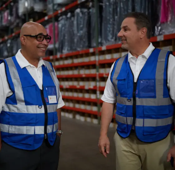 Two Boxzooka team members talking in branded vests