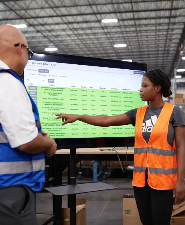 Boxzooka team reviewing a support ticket queue on a monitor