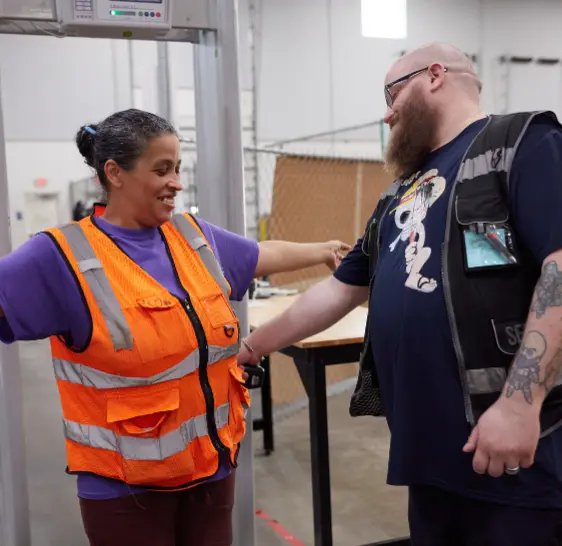 Two Boxzooka employees at a security checkpoint in the warehouse