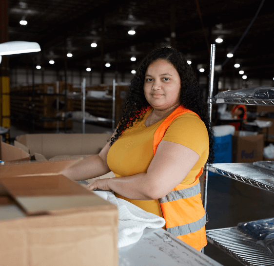 Boxzooka warehouse associate standing at a packing station