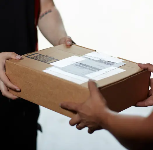 Close up of a package being handed off between two people