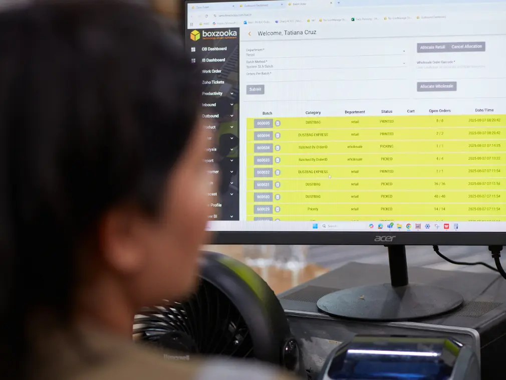 Employee using Boxzooka’s warehouse management system (WMS) dashboard to track and manage fulfillment operations in real time.
