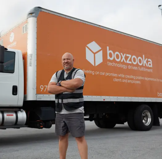 Boxzooka employee standing in front of a branded delivery truck