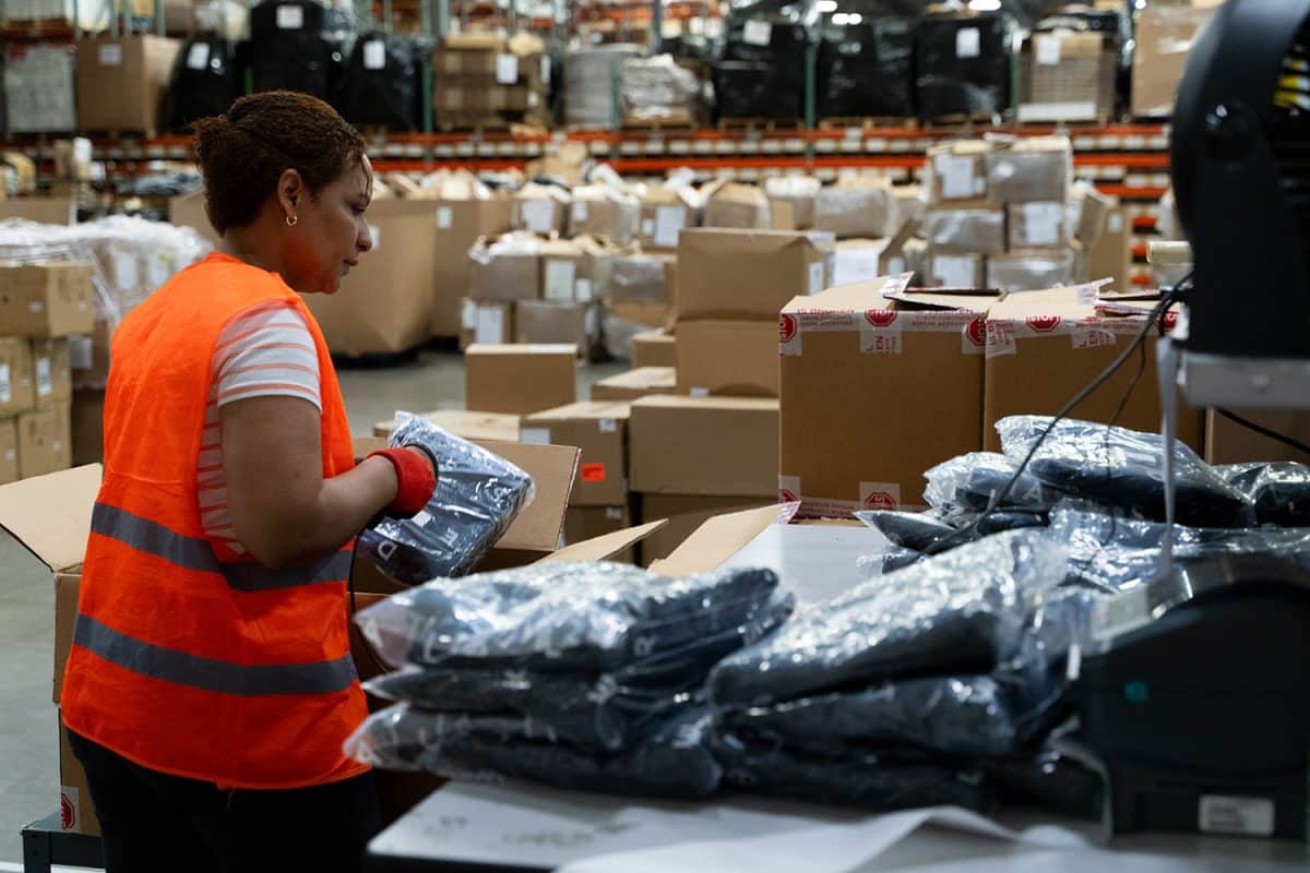 woman scans apparel items at a 3PL shipping station