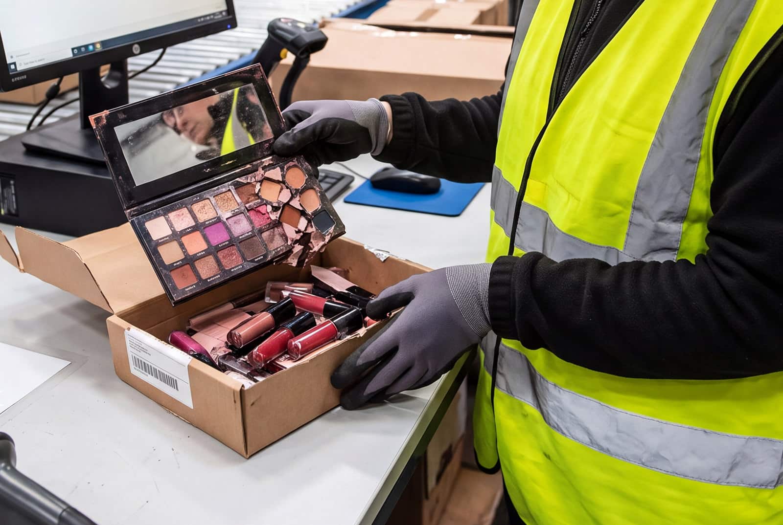 a worker handles beauty products returns at a fulfillment center