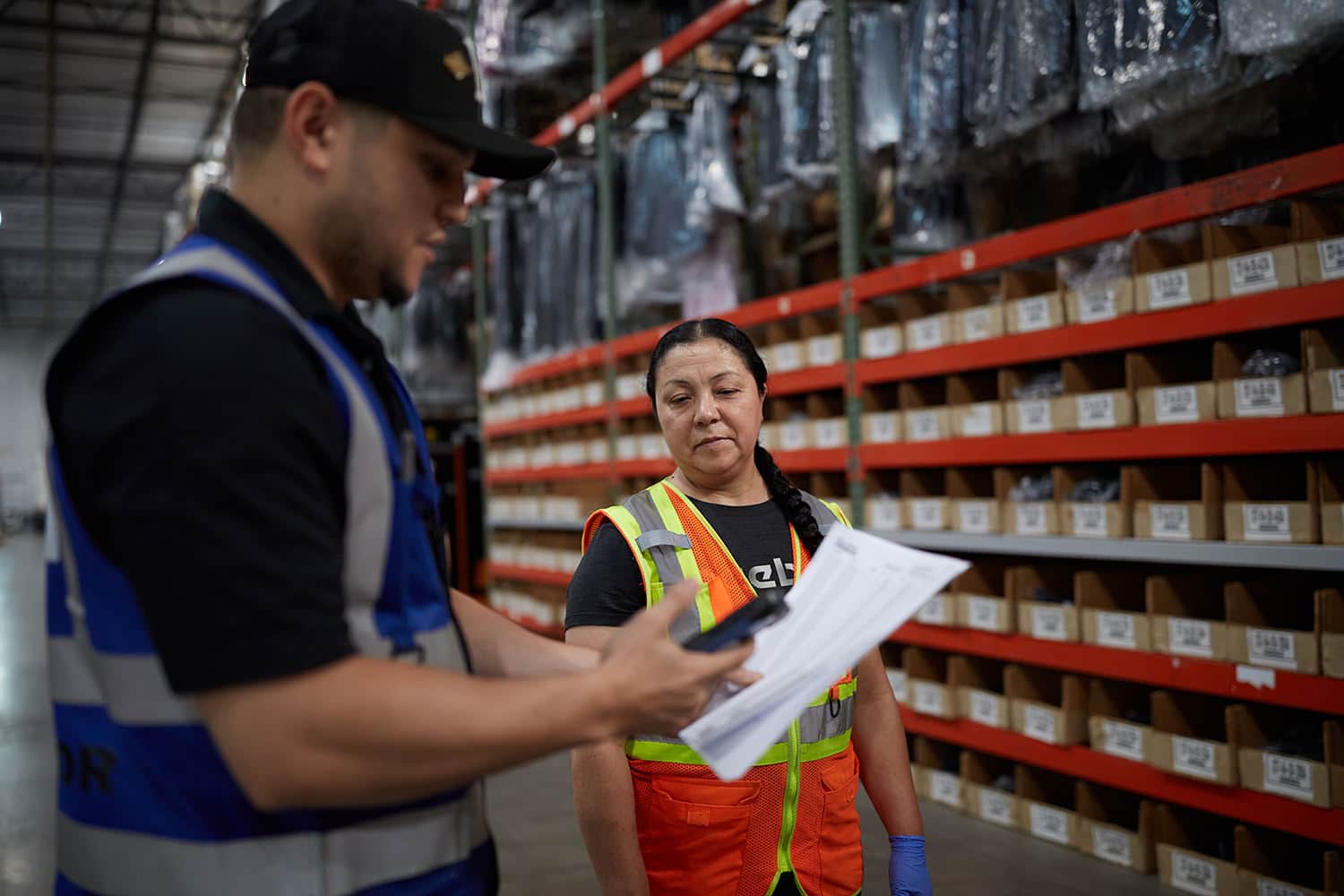 workers in a fulfillment center scan a paper