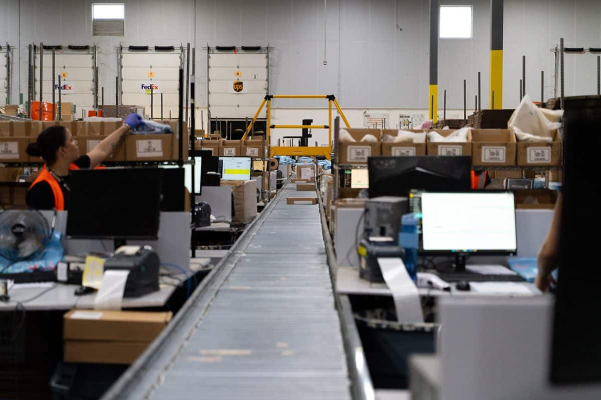 orders flow down a line in a fulfillment warehouse