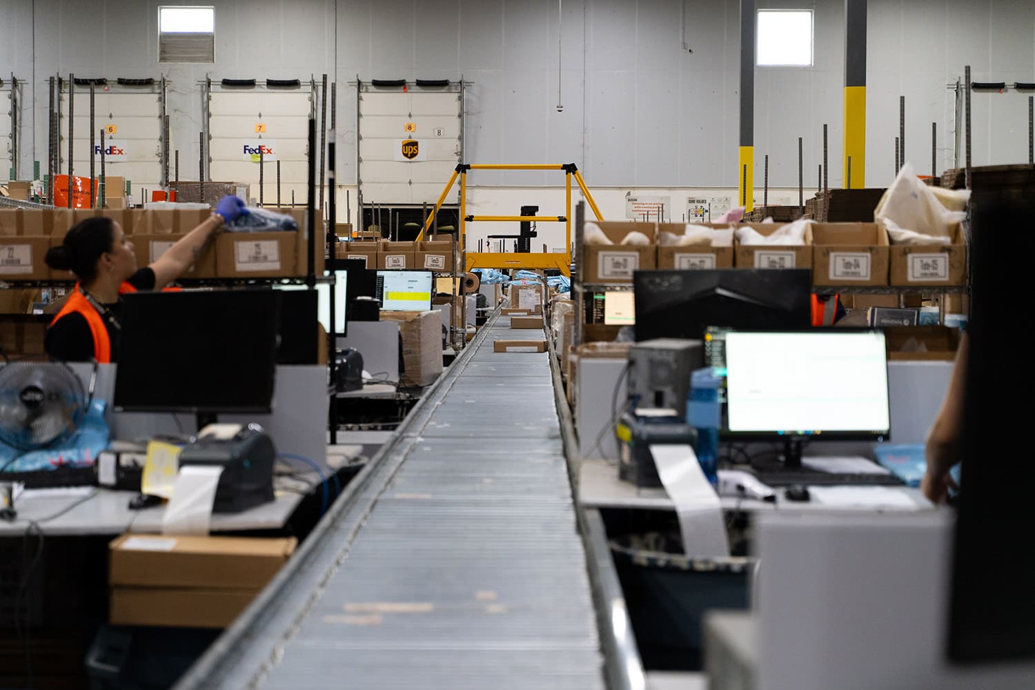 orders flow down a line in a fulfillment warehouse