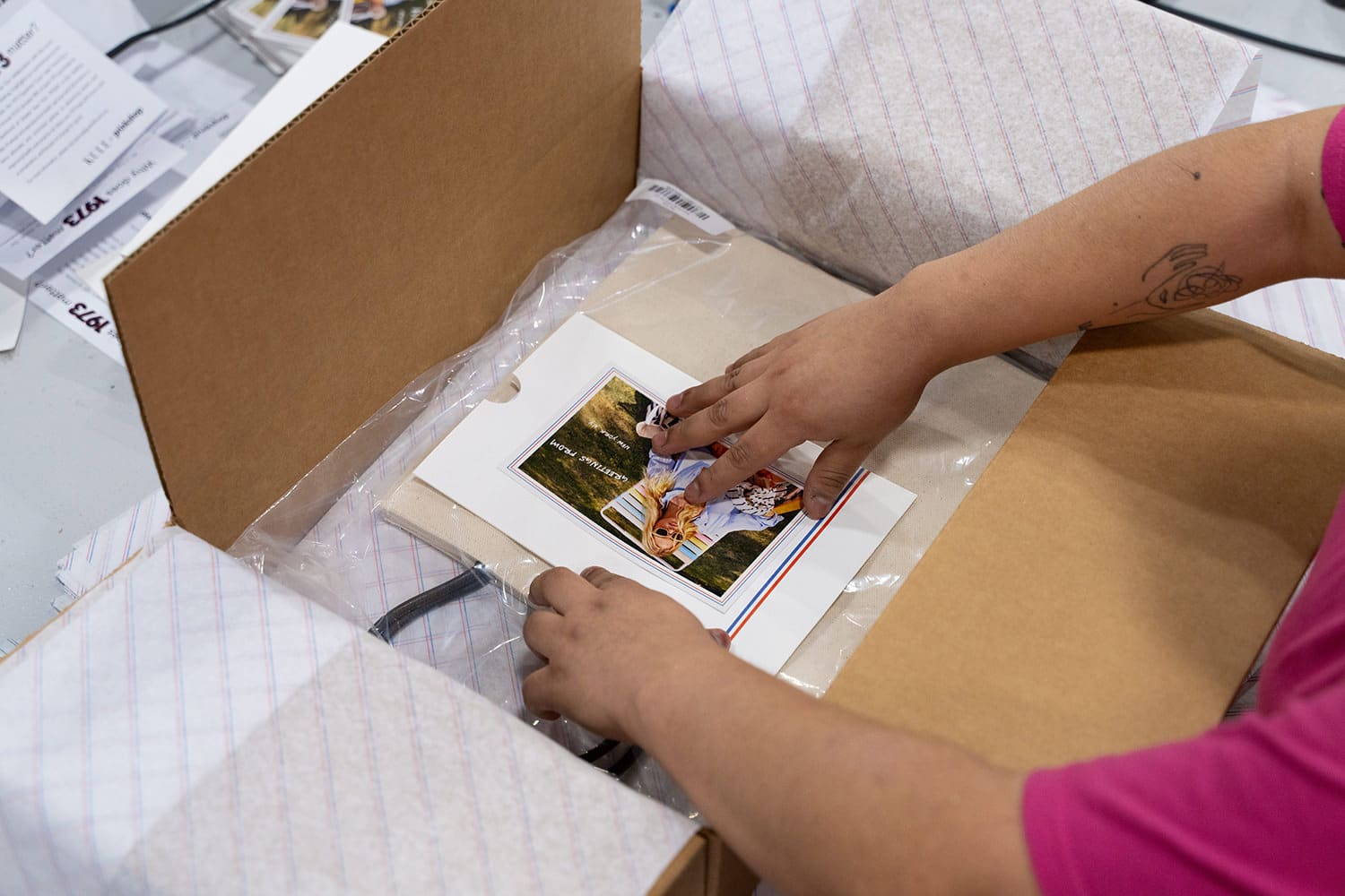 3PL worker places a kitted product inside a box